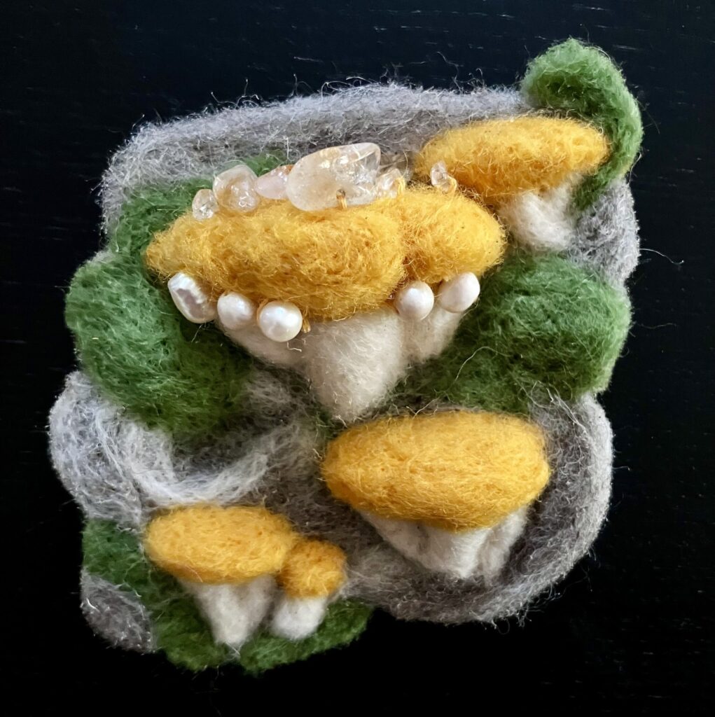 Needlefelted mushrooms with pearls sewn on.