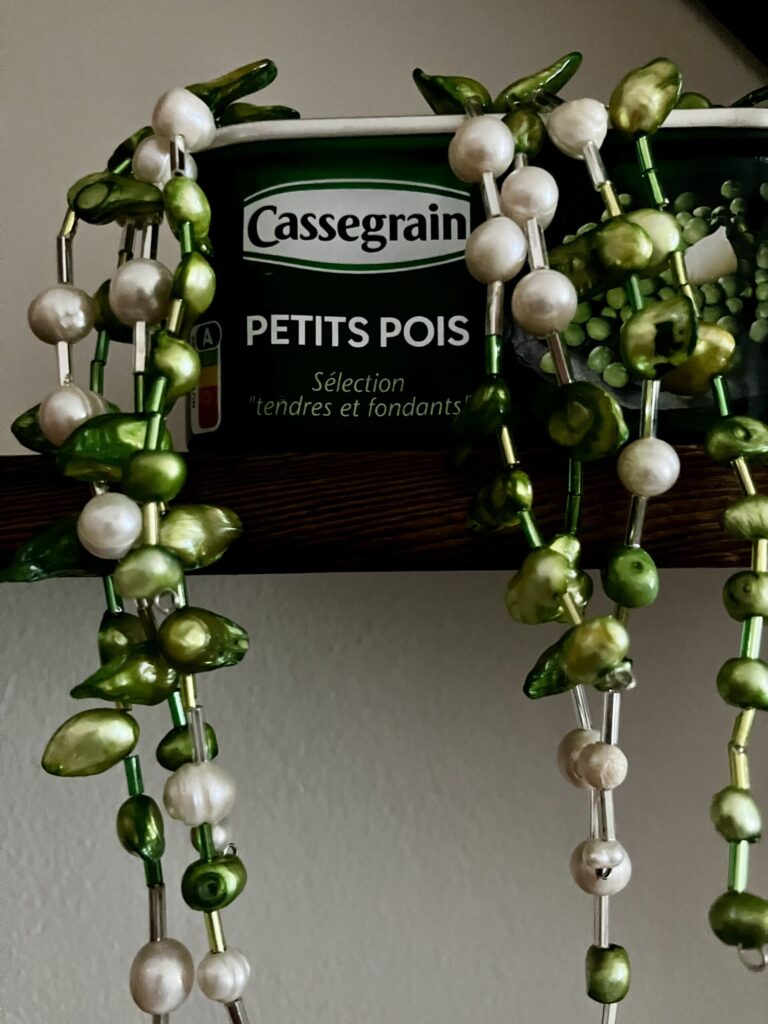 A closeup photo of a fake string of pearls plant.