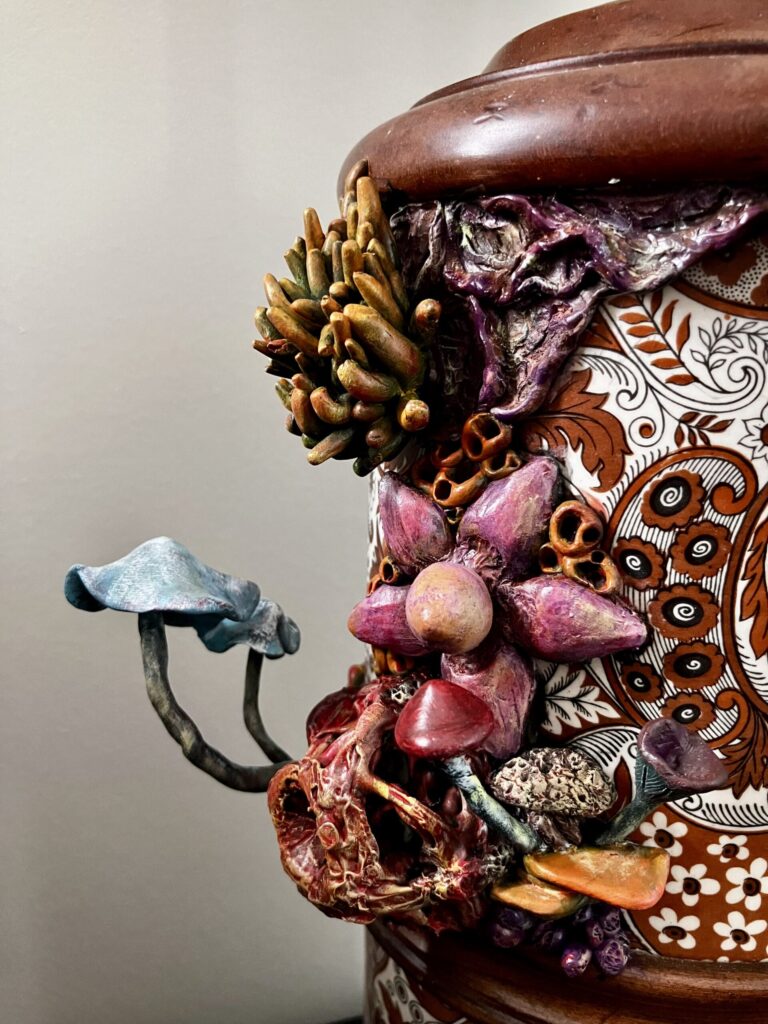 A close up photo of sculpted mushrooms on a lamp.
