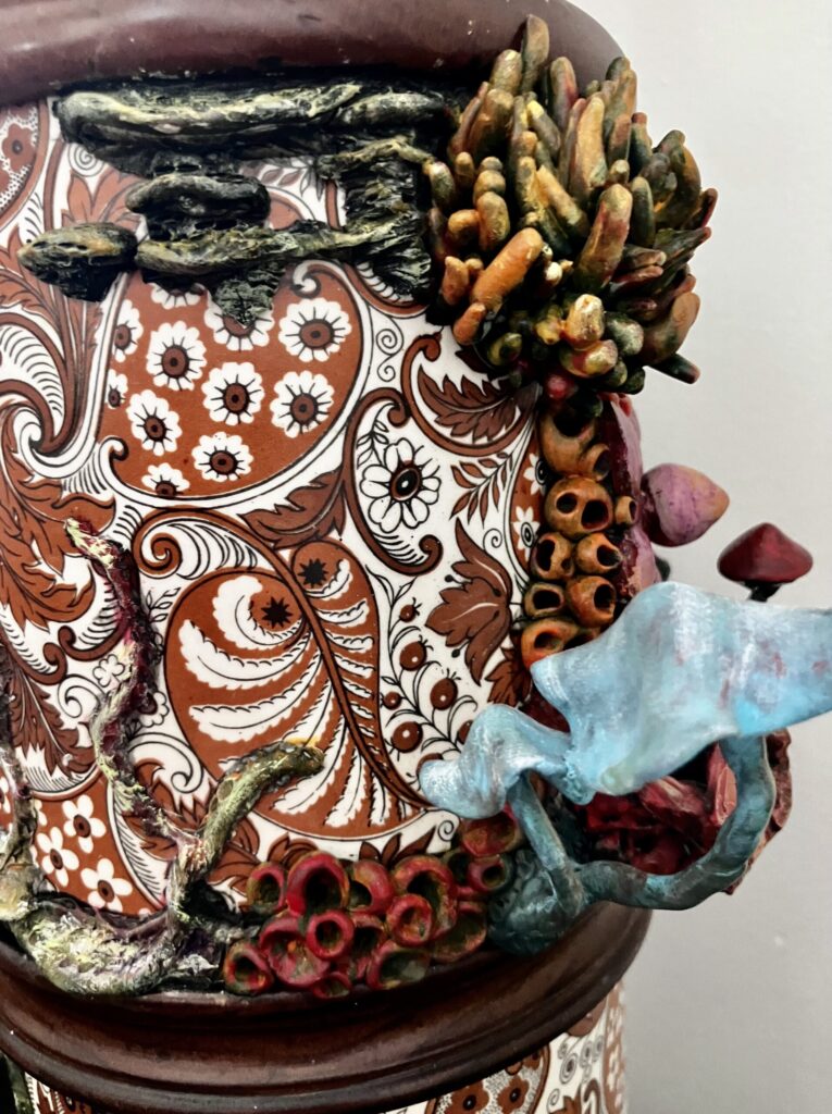 A close up photo of sculpted mushrooms on a lamp.