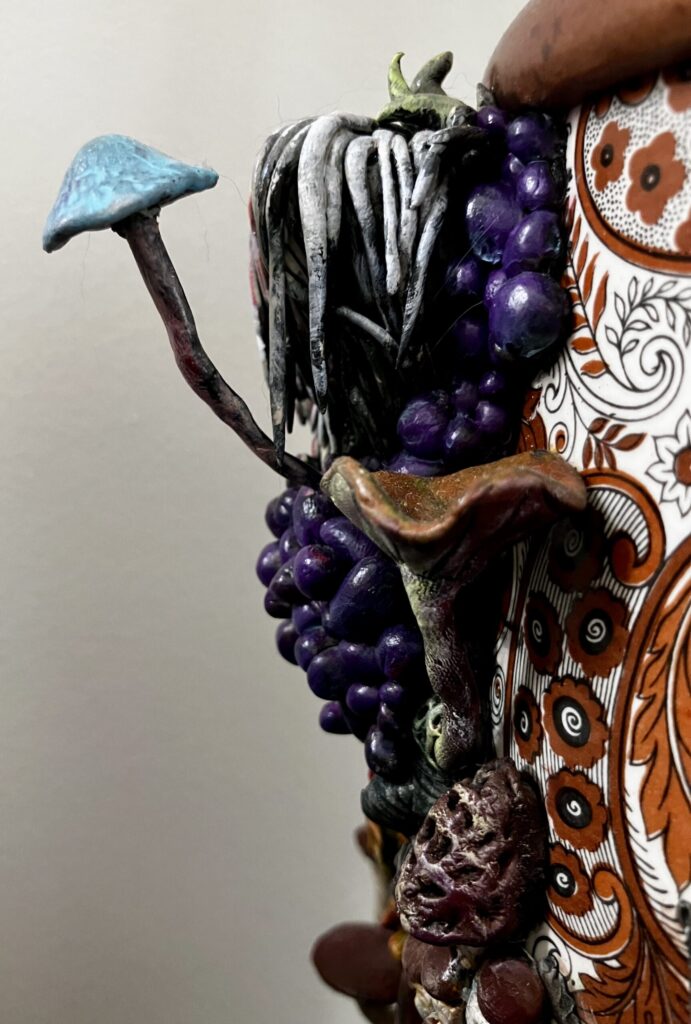 A close up photo of sculpted mushrooms on a lamp.