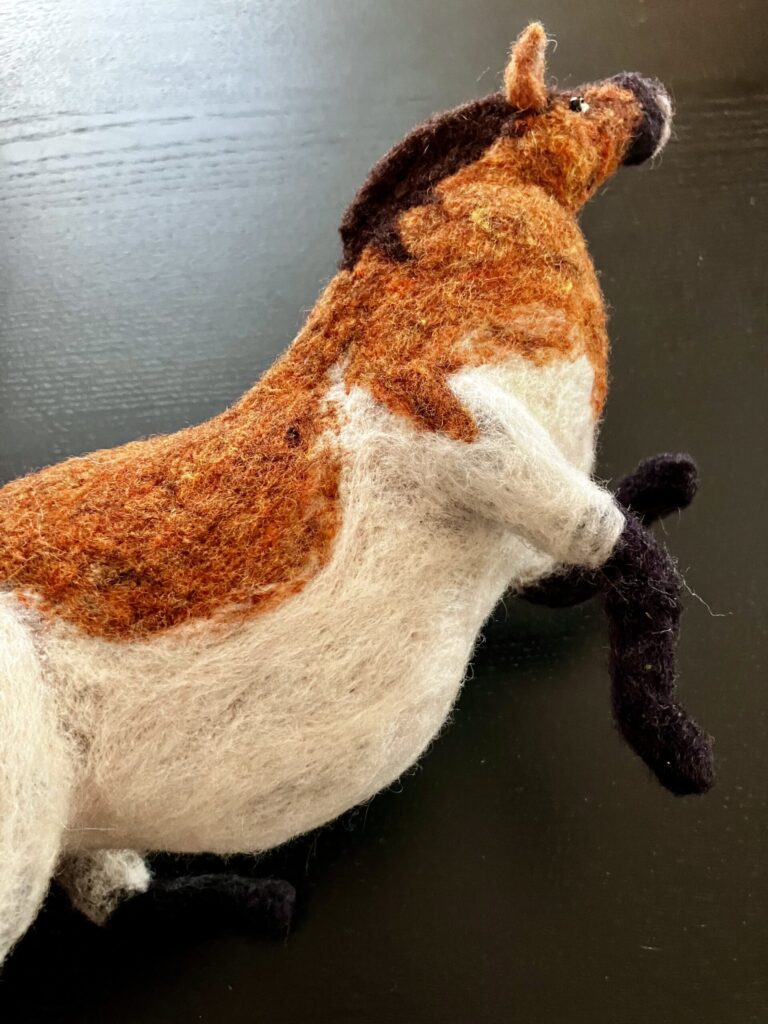 A needlefelted fat horse.