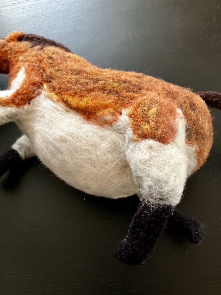 A needlefelted fat horse.