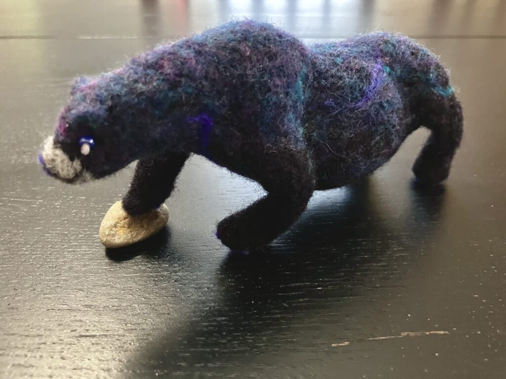 A needlefelted bear with stars on its side in the shape of the Big Dipper.
